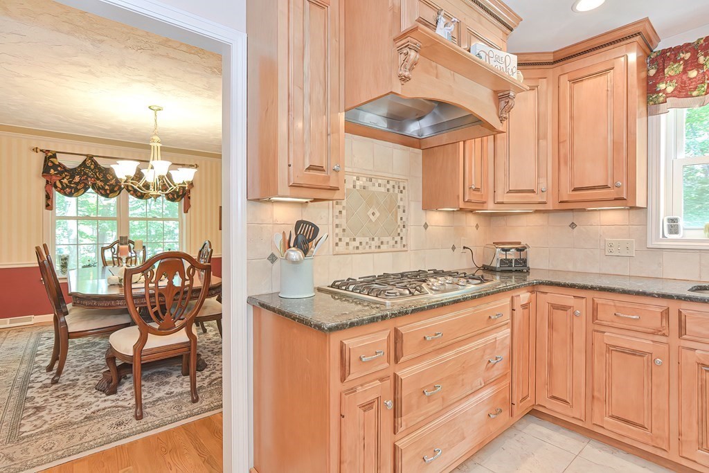 2 Harrison Place Franklin, MA 02038 - Photo 11 of 34 a kitchen with granite countertop white cabinets and window