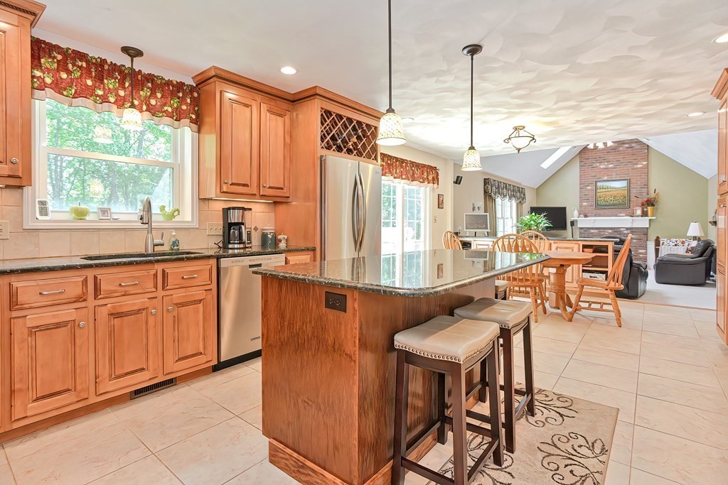 2 Harrison Place Franklin, MA 02038 - Photo 8 of 34 a kitchen with stainless steel appliances granite countertop table chairs and a large window