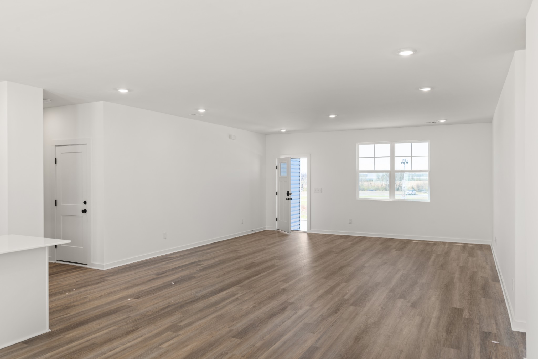 219 Reece Road Baxter, TN 38544 - Photo 6 of 10 an empty room with wooden floor and windows