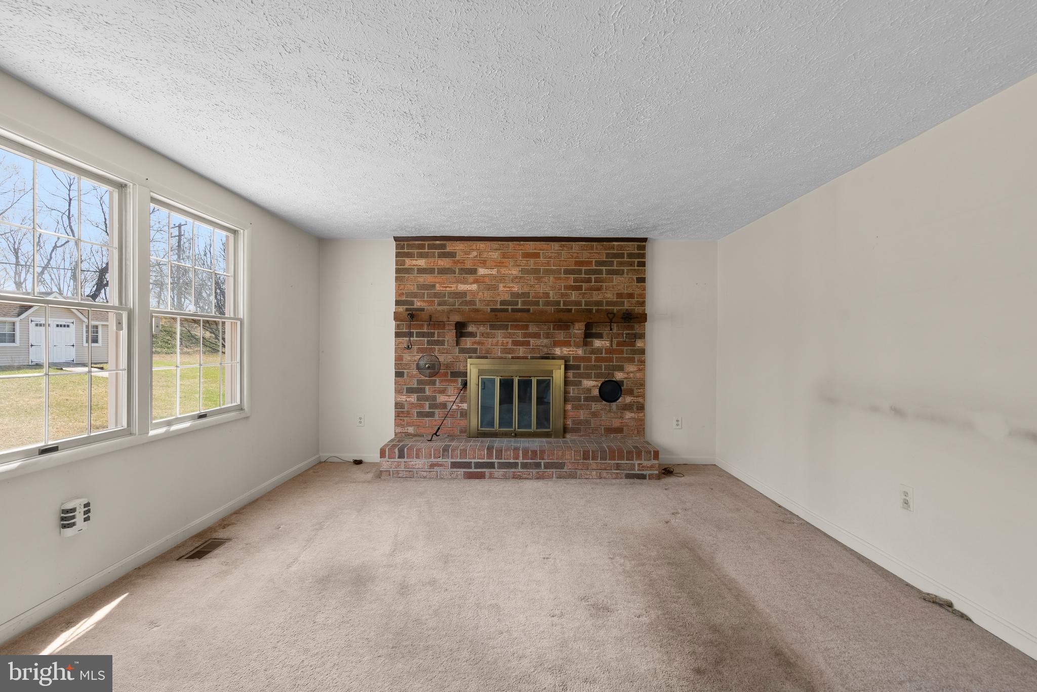 8745 Cardinal Forest Circle Laurel, MD 20723 - Photo 11 of 43 an empty room with a fireplace and large window
