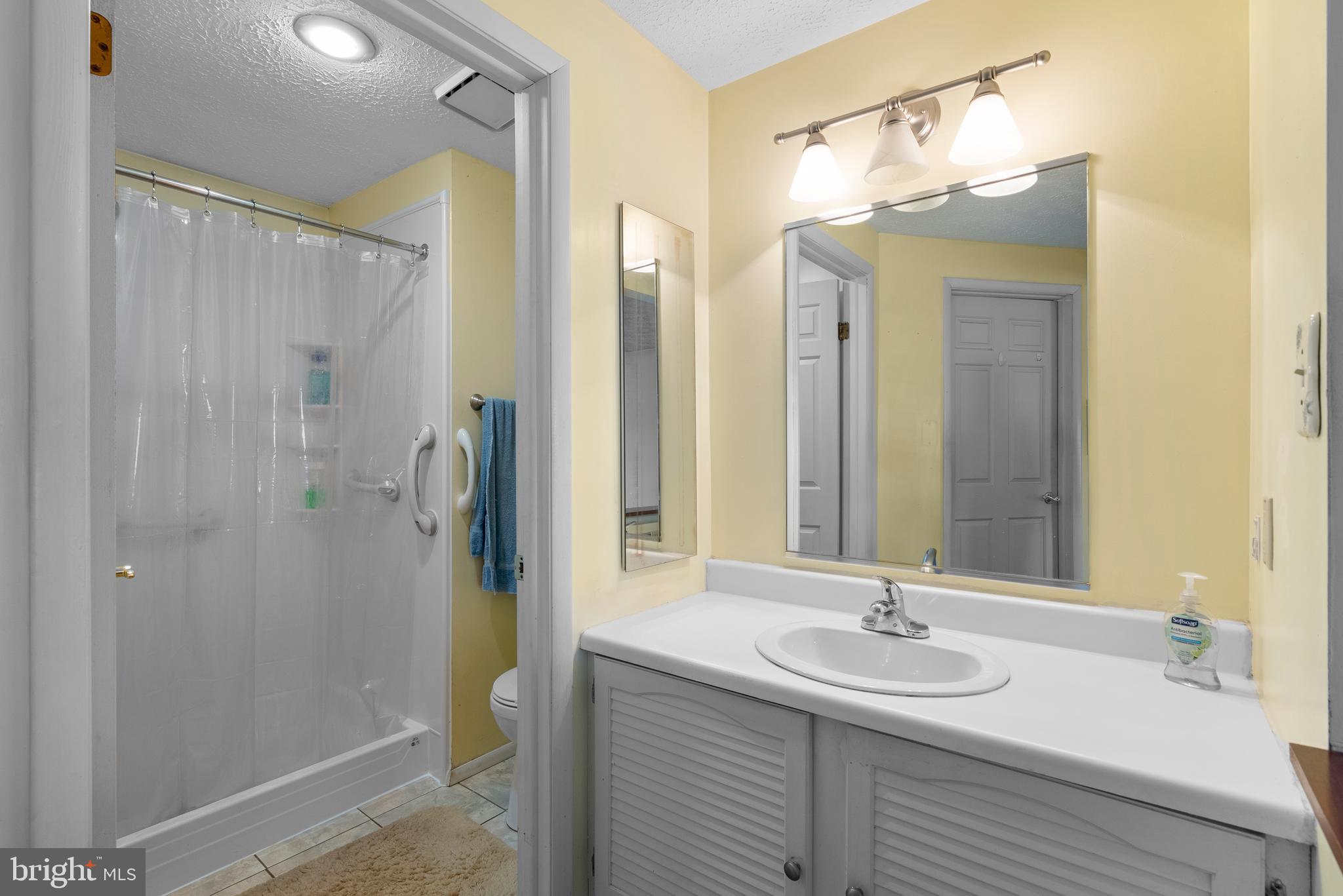 8745 Cardinal Forest Circle Laurel, MD 20723 - Photo 24 of 43 a bathroom with a double vanity sink mirror and shower