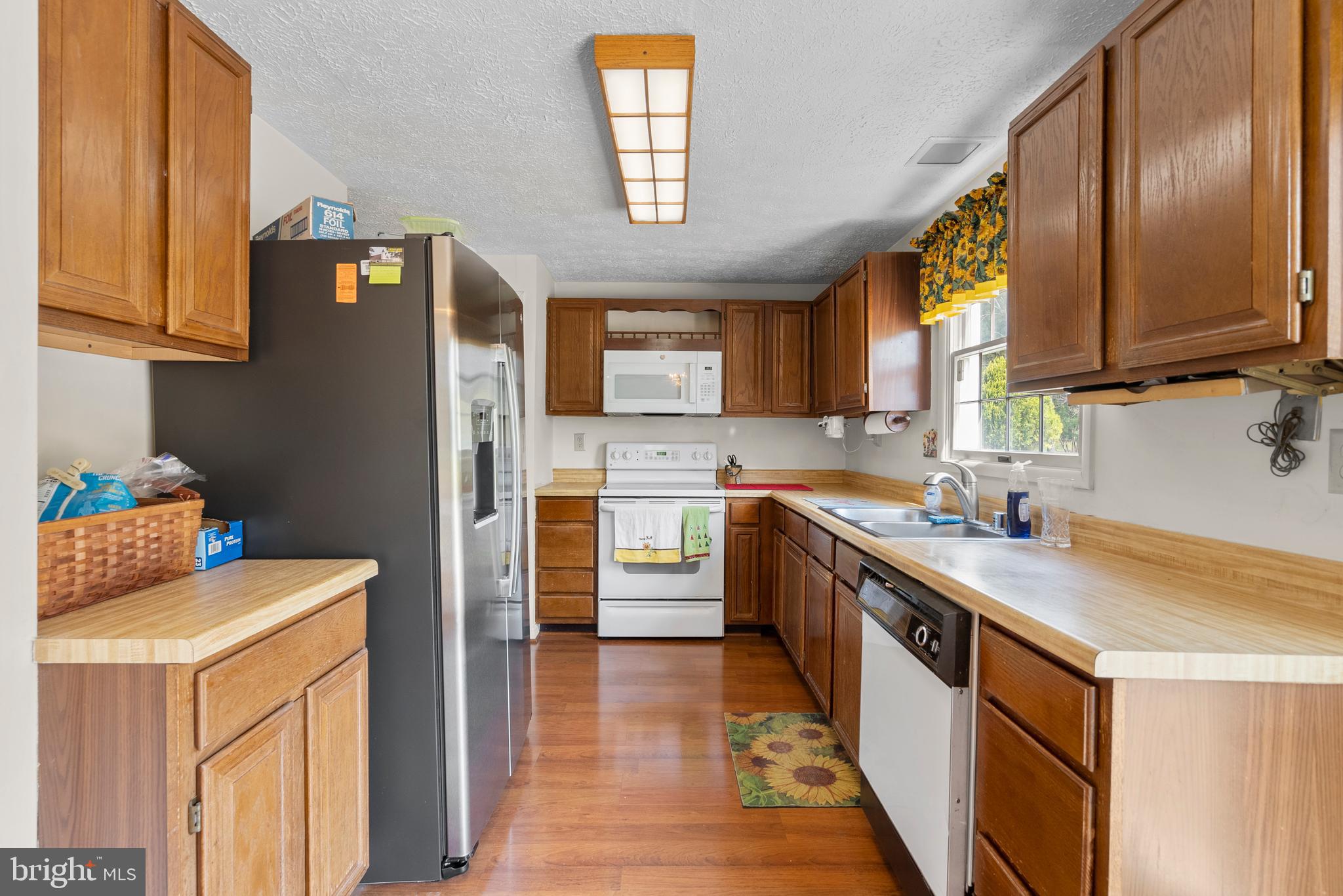 8745 Cardinal Forest Circle Laurel, MD 20723 - Photo 6 of 43 a kitchen with stainless steel appliances sink a stove and a refrigerator
