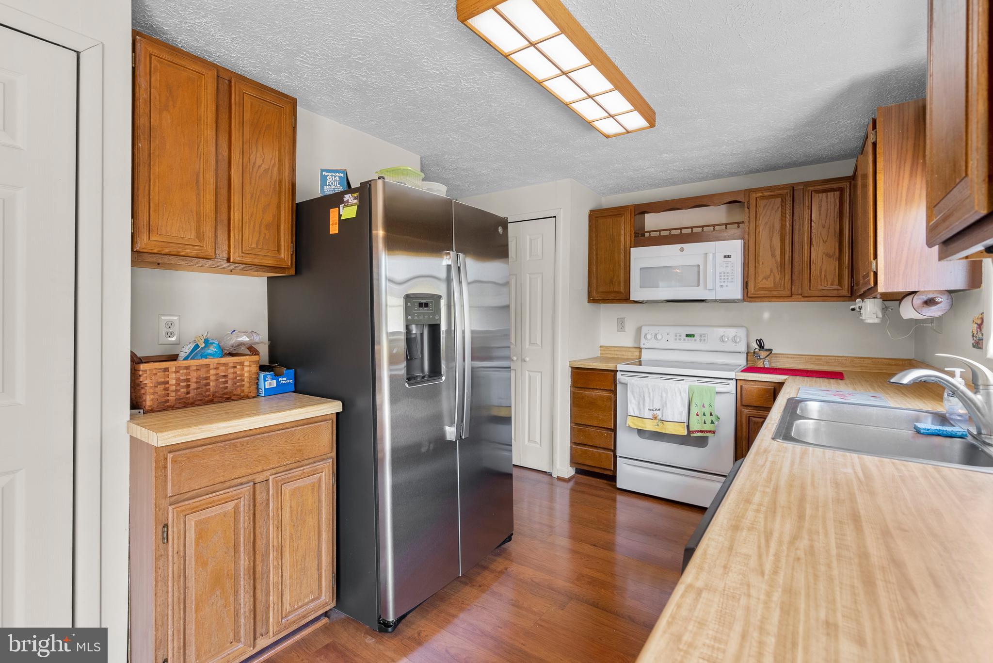 8745 Cardinal Forest Circle Laurel, MD 20723 - Photo 7 of 43 a kitchen with a refrigerator sink and cabinets