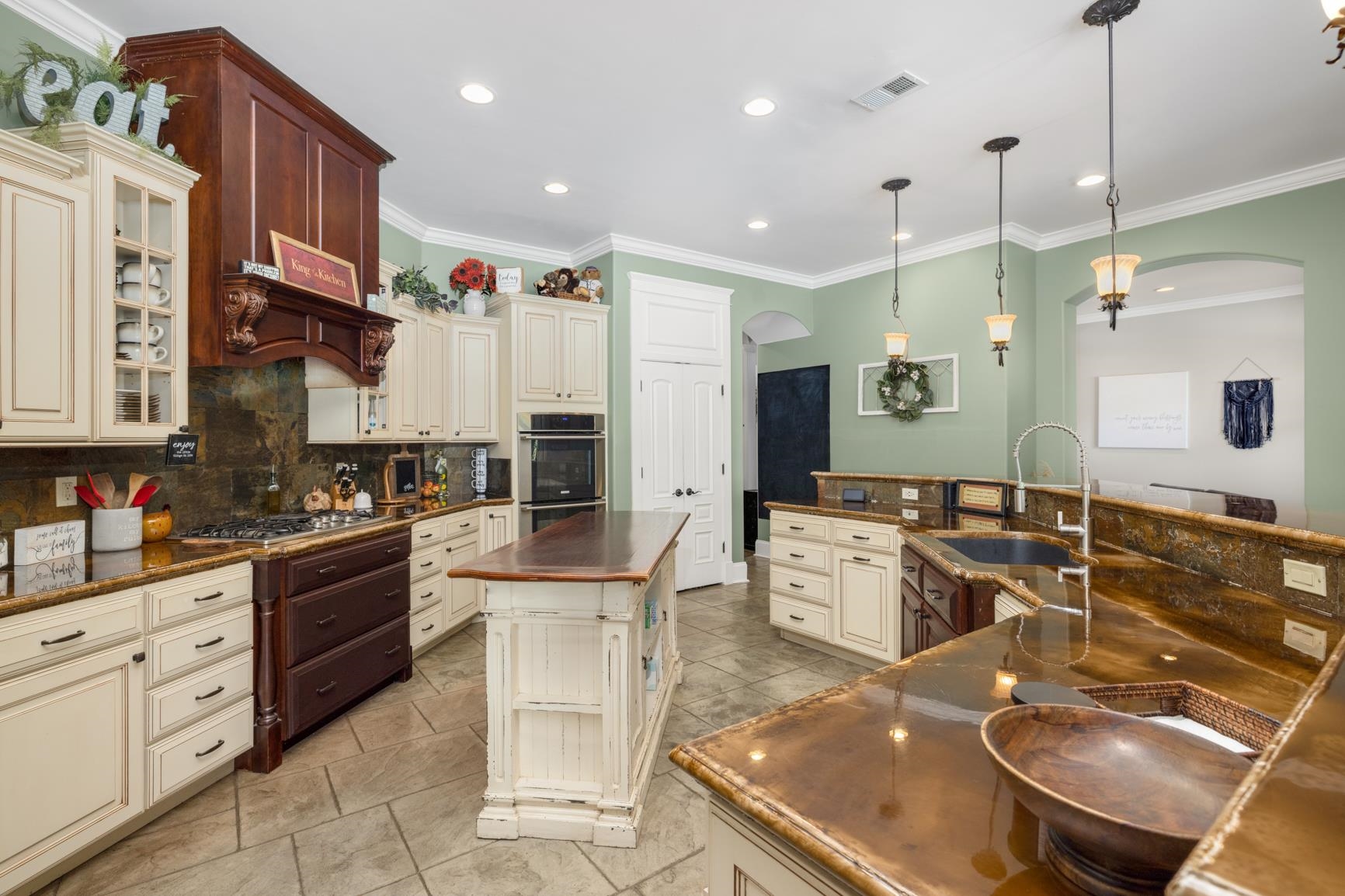 746 Kelly Corner Road Covington, TN 38019 - Photo 10 of 40 Kitchen featuring sink, tasteful backsplash, and cream cabinets