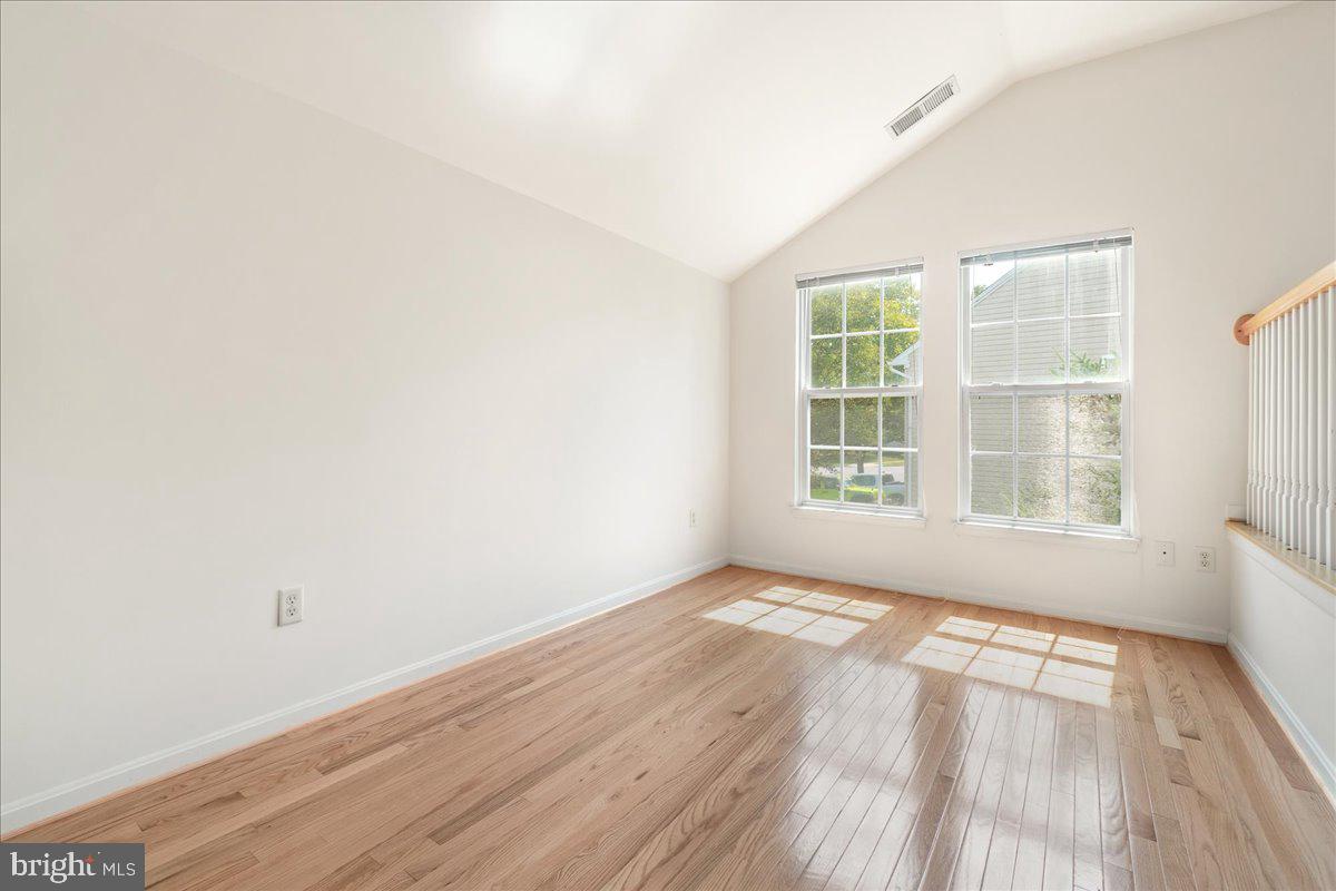1712 Wheyfield Drive Frederick, MD 21701 - Photo 28 of 64 an empty room with wooden floor and windows