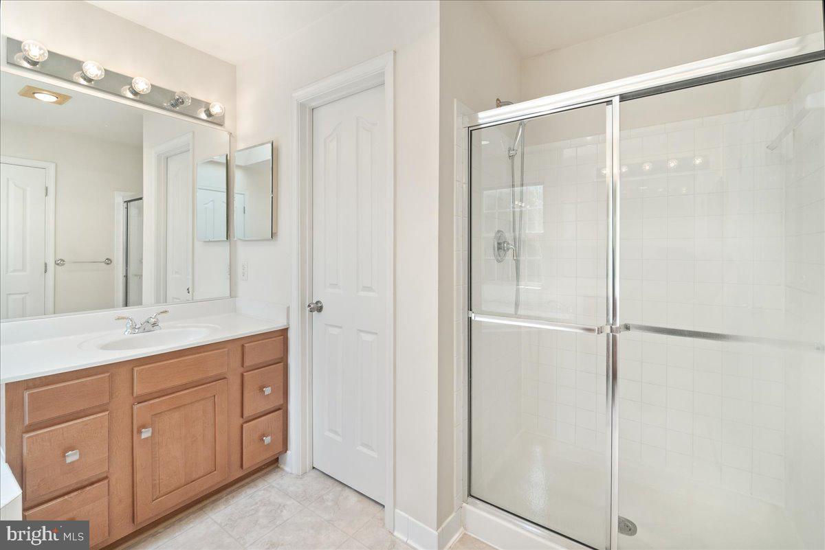 1712 Wheyfield Drive Frederick, MD 21701 - Photo 33 of 64 a bathroom with a shower sink and mirror
