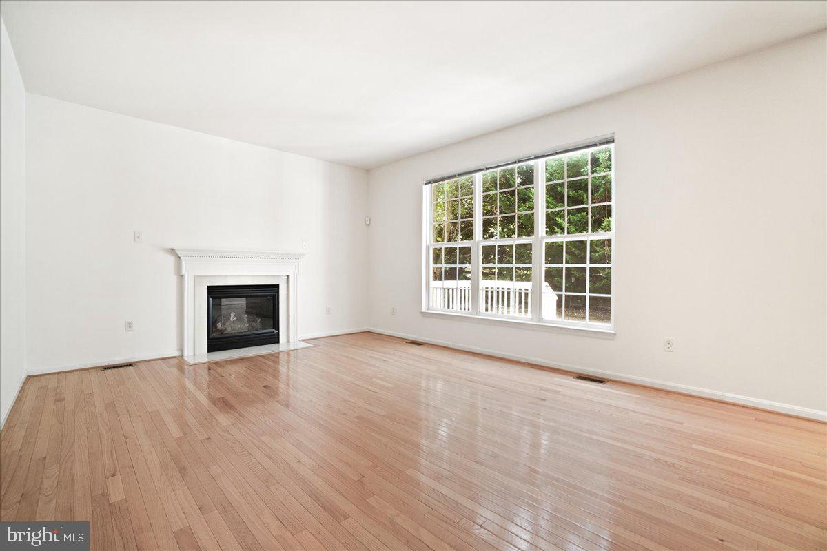 1712 Wheyfield Drive Frederick, MD 21701 - Photo 4 of 64 an empty room with wooden floor and fireplace