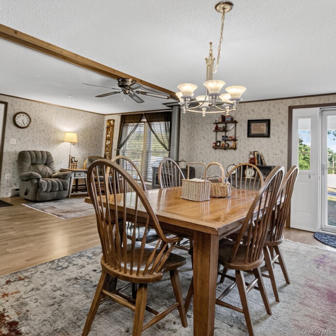 69 Crabby Road Loch Sheldrake, NY 12759 - Photo 12 of 20 a view of a dining room with furniture and chandelier