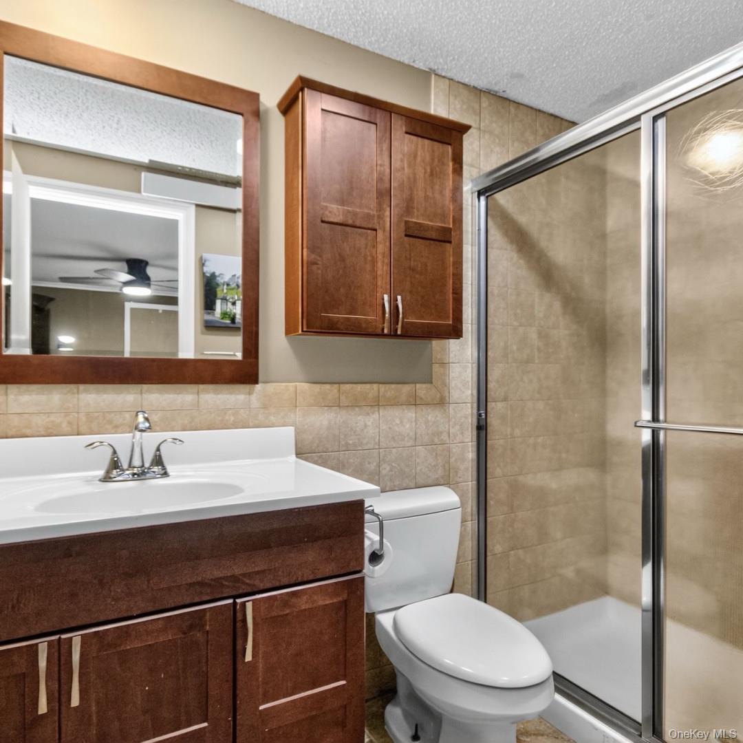 69 Crabby Road Loch Sheldrake, NY 12759 - Photo 19 of 20 a bathroom with a sink a toilet and shower