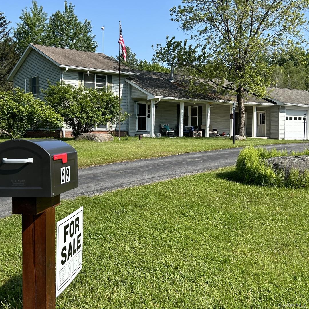 69 Crabby Road Loch Sheldrake, NY 12759 - Photo 3 of 20 a front view of a house with a garden