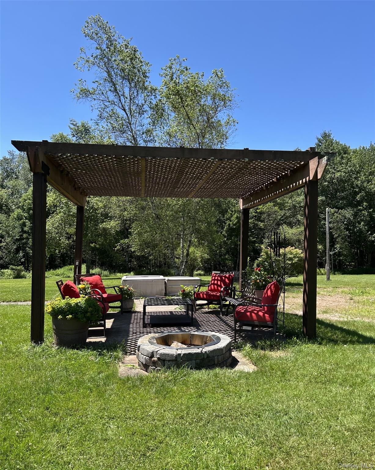 69 Crabby Road Loch Sheldrake, NY 12759 - Photo 6 of 20 a view of a backyard with table and chairs under an umbrella