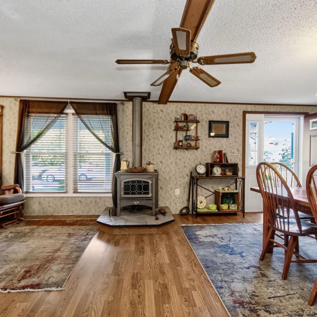 69 Crabby Road Loch Sheldrake, NY 12759 - Photo 10 of 20 a living room with furniture a flat screen tv and a large window