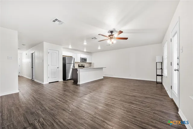 a view of a kitchen with a stove cabinets and wooden floor