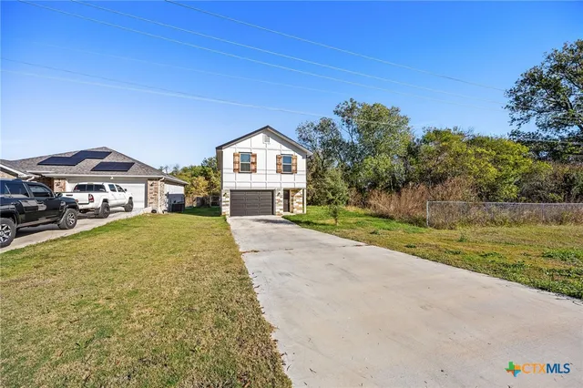 a front view of a house with a yard