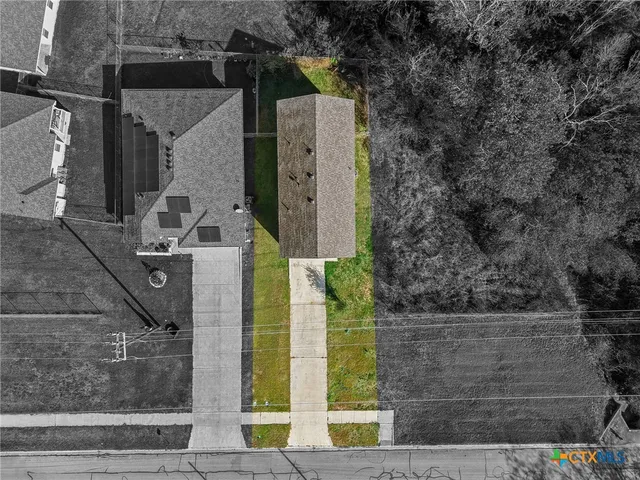 front view of a house with a tree