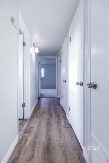 252 North Norma Street Ridgecrest, CA 93555 - Photo 6 of 18 a view of a hallway with wooden floor and closet area