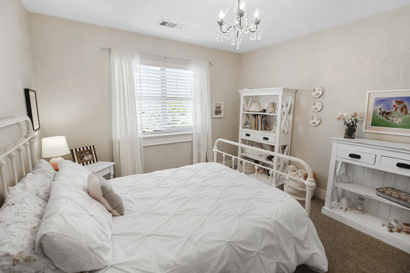 893 Ridgeview Drive Eagle Point, OR 97524 - Photo 38 of 49 a bedroom with a bed and a chandelier