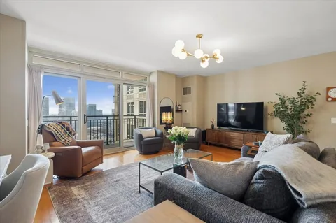 a living room with furniture wooden floor and a flat screen tv