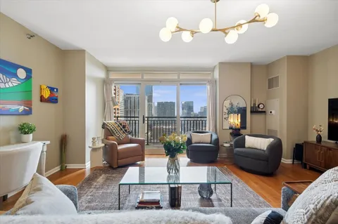 a living room with furniture potted plant and a large window