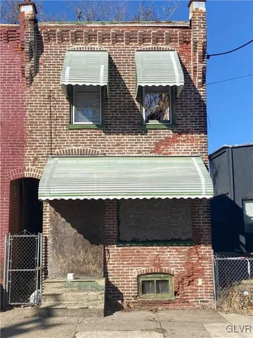 a front view of a building with parking space