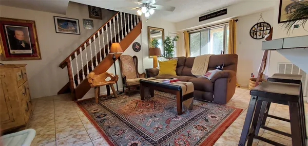 a living room with furniture a rug and a window