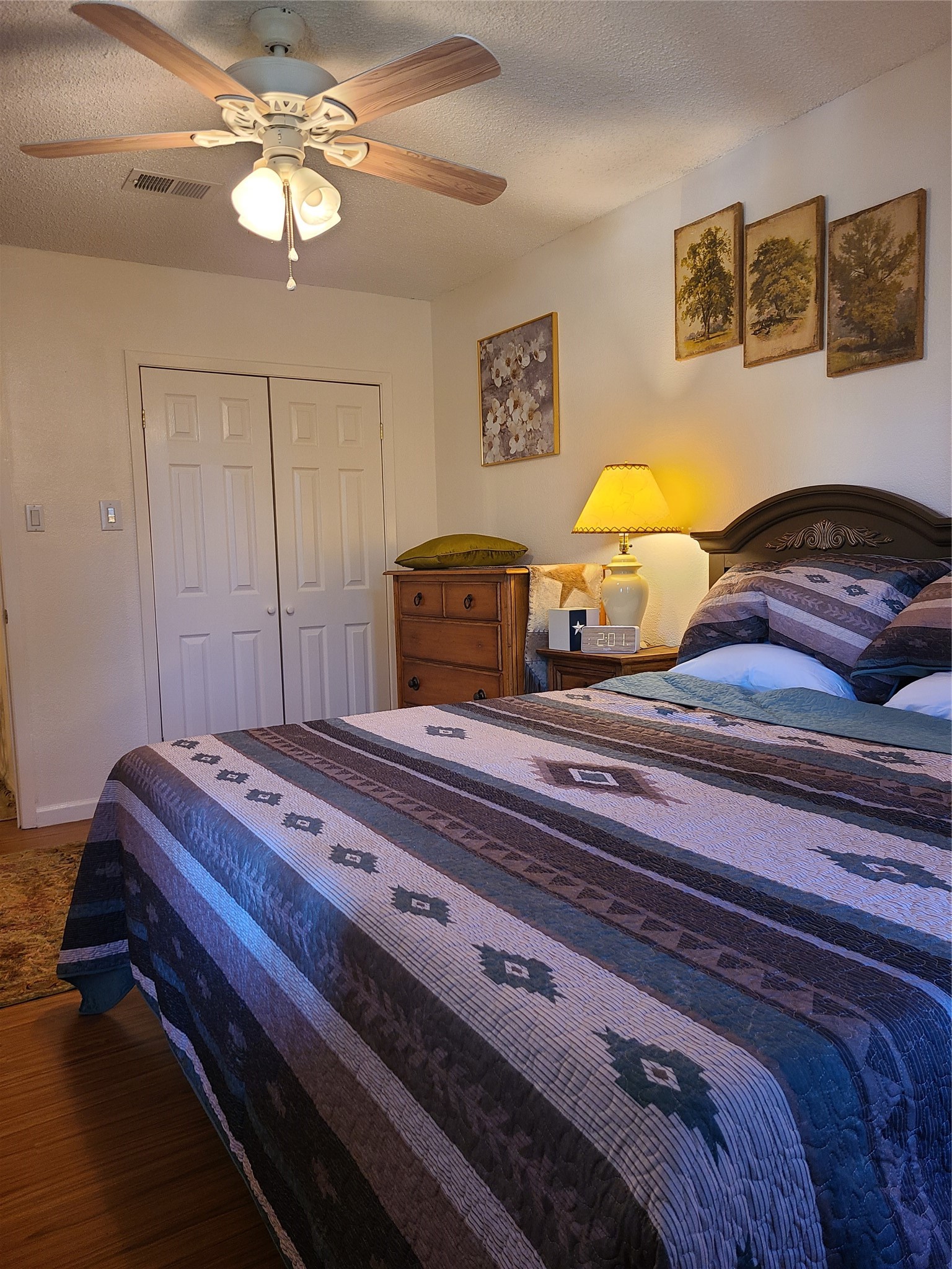 17018 Water Oak Drive Channelview, TX 77530 - Photo 29 of 40 a bedroom with a bed and a chandelier