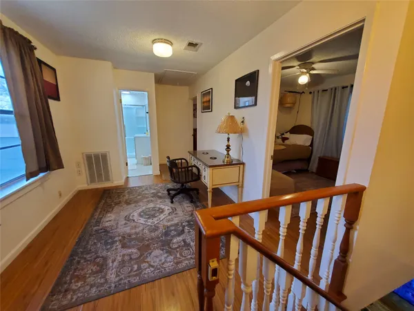 a view of a hallway to a livingroom with furniture