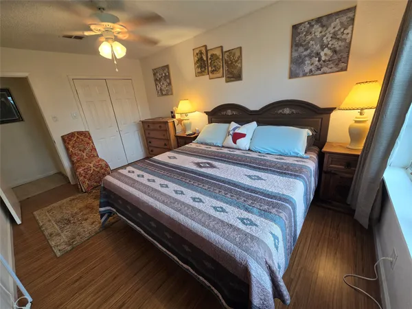 a kitchen with stainless steel appliances granite countertop a refrigerator a stove and a sink with wooden floor