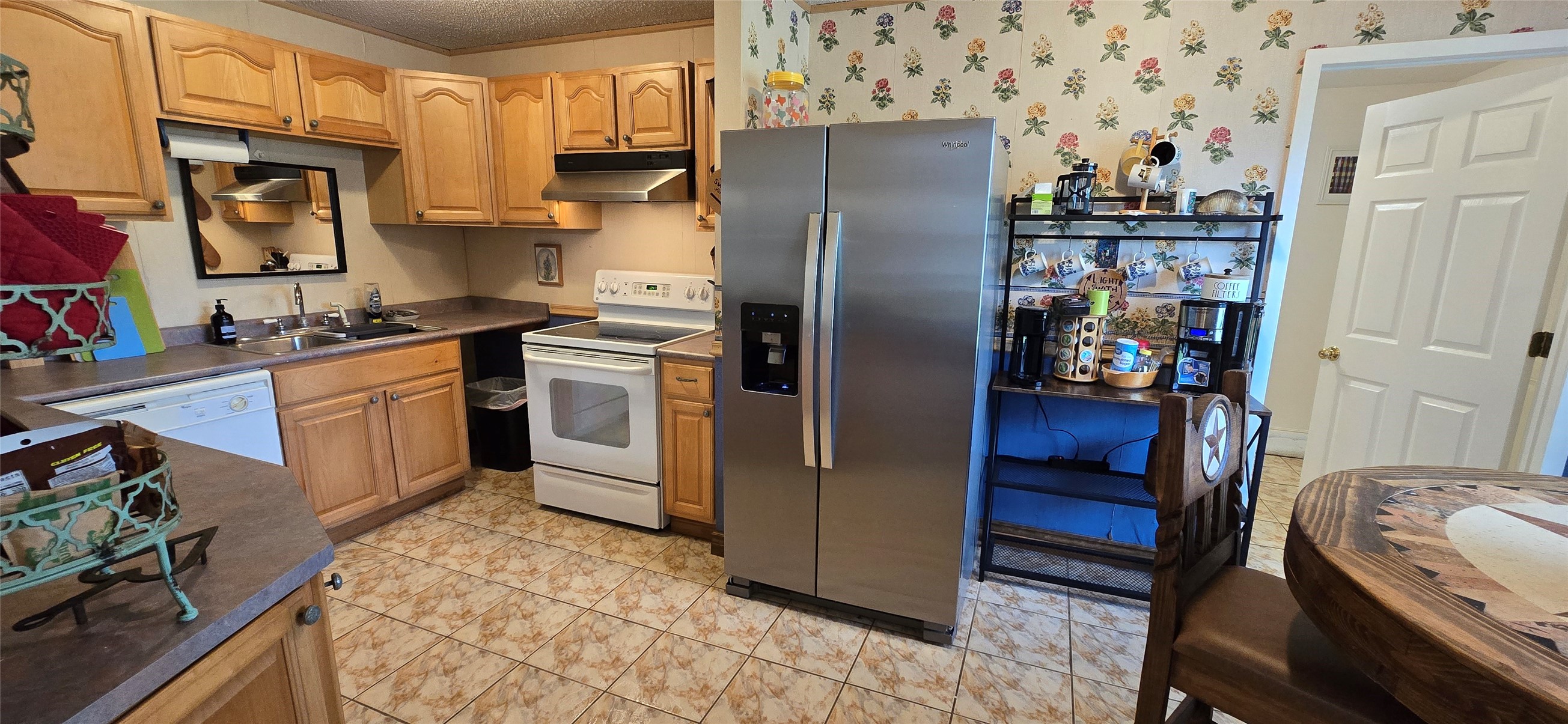 17018 Water Oak Drive Channelview, TX 77530 - Photo 39 of 40 a kitchen with stainless steel appliances granite countertop a refrigerator a stove and a sink with wooden floor