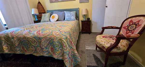 a bedroom with a bed and a mirror