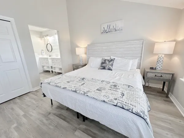 a bedroom with a bed and a wall painting