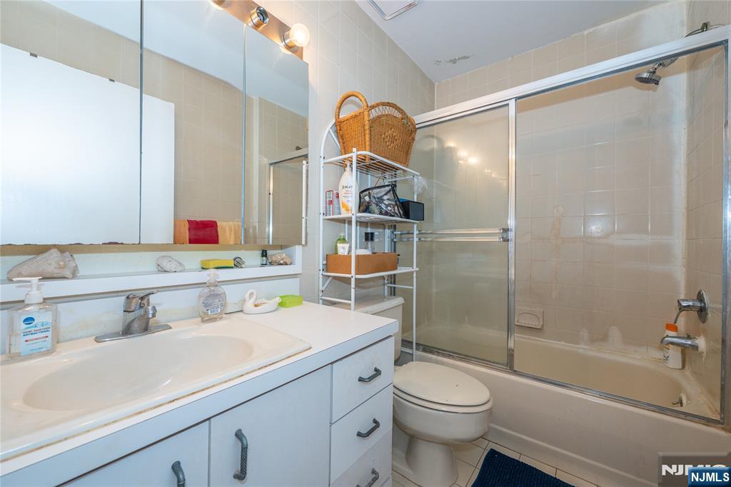 75 Union Street, Unit 5E Hackensack, NJ 07601 - Photo 17 of 24 a bathroom with a sink toilet and shower