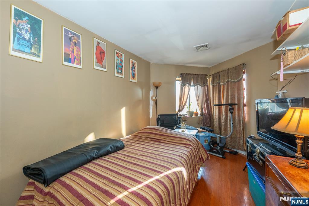 75 Union Street, Unit 5E Hackensack, NJ 07601 - Photo 18 of 24 a bedroom with bed and wooden floor