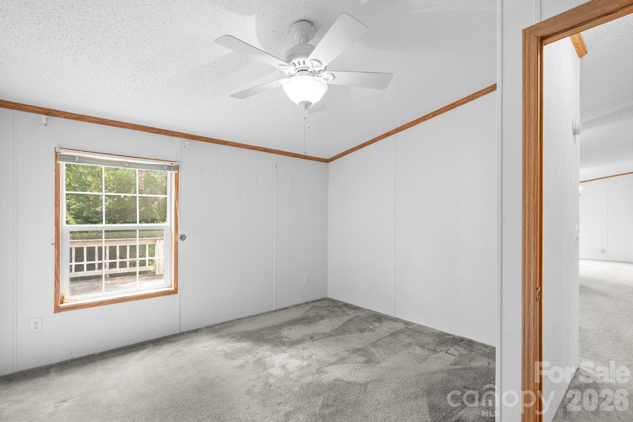 133 Spivey Mountain Road Asheville, NC 28806 - Photo 20 of 40 an empty room with windows and fan