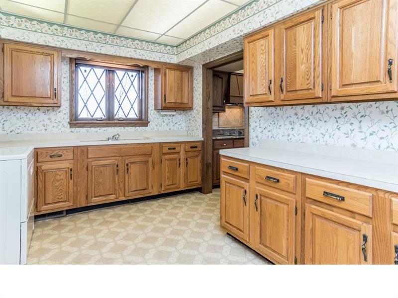 714 Clearfield Road Fenelton, PA 16034 - Photo 8 of 25 Through the pocket door off the kitchen you'll find a massive laundry room with double sink and room for 2 washers and a dryer.
