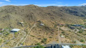 a view of a dry yard with mountains in the background