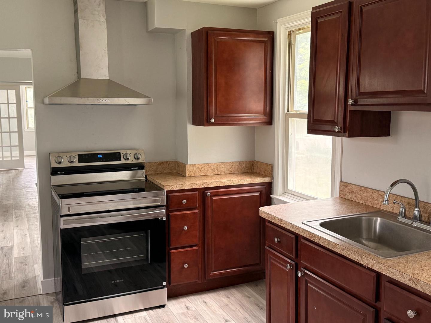 217 Smith Street Salem, NJ 08079 - Photo 8 of 23 a kitchen with granite countertop a sink stove and microwave