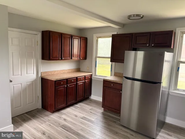 a kitchen with granite countertop a sink stove and microwave