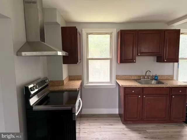 a kitchen with stainless steel appliances granite countertop a refrigerator a stove a sink and a refrigerator