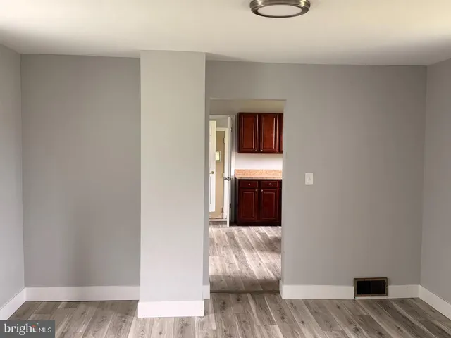 a kitchen with a refrigerator sink and wooden cabinets