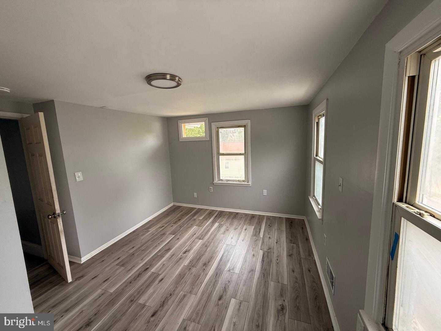 217 Smith Street Salem, NJ 08079 - Photo 14 of 23 an empty room with wooden floor and windows
