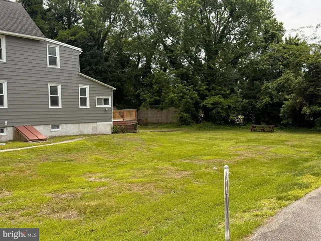 a front view of house with yard and swimming pool