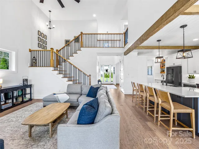 a living room with furniture a rug and white walls