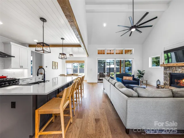 a living room with fireplace furniture and a wooden floor