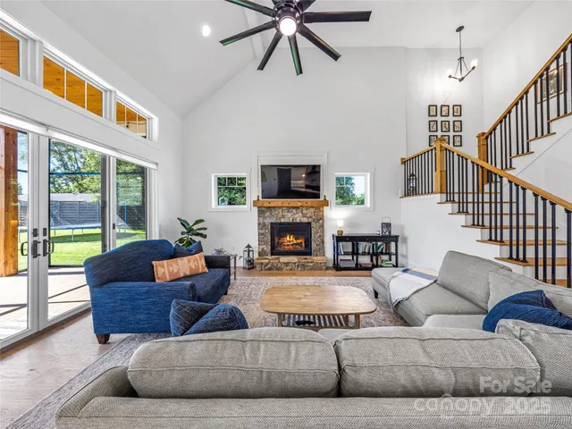 a living room with fireplace furniture and a large window