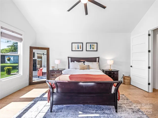 a bedroom with a bed and wooden floor