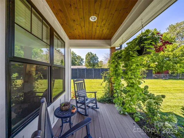 a view of a chairs and table in patio with a yard