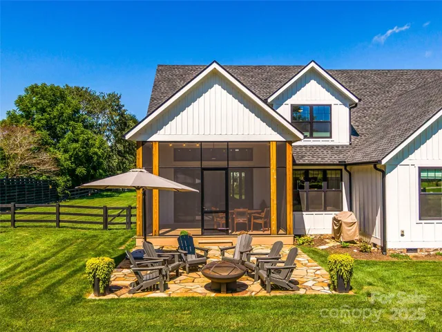 a view of a house with pool and chairs