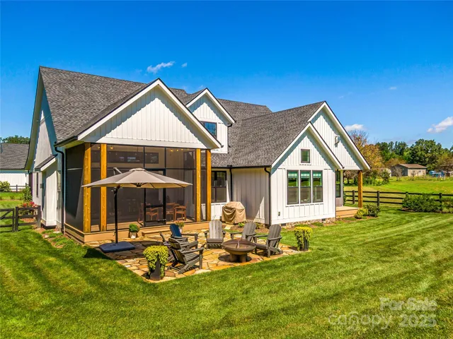 a view of a house with backyard porch and sitting area