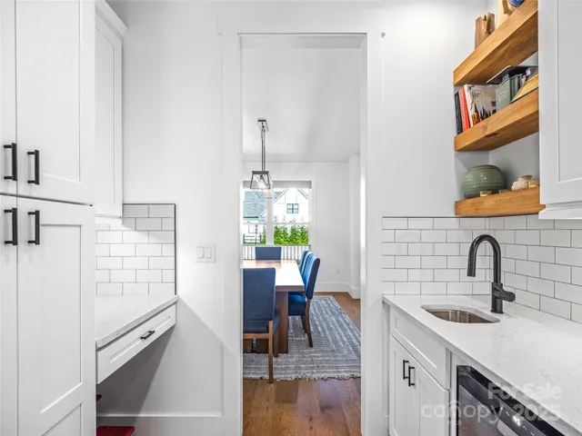 a view of a kitchen with a sink and cabinets